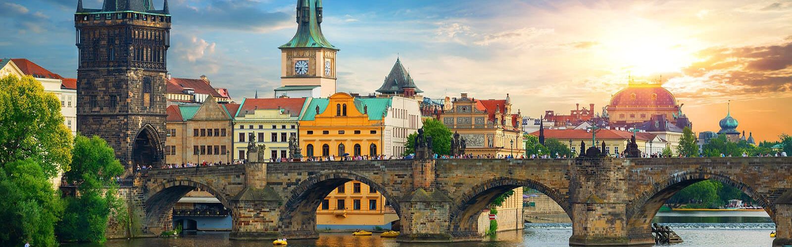 Skyline view of Prague at sunset with the bridge as the main subject.